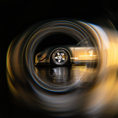 Gold sports-car wheel and body framed by circular Black Hole distortion