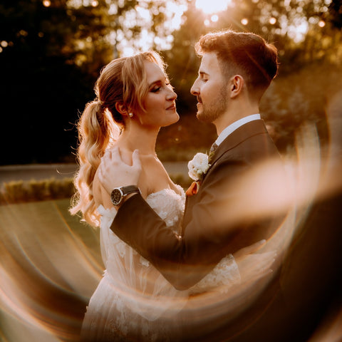 Wedding couple in warm light with curved optical softness around their portrait