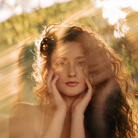 Backlit Supernova II portrait with layered ghost images around a curly-haired woman